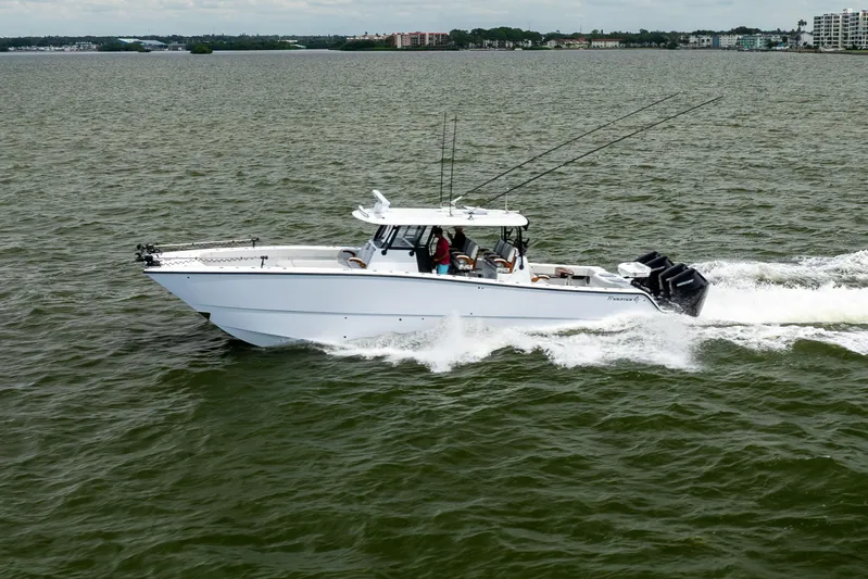  Yacht Photos Pics 2025 Freeman 42 LR boat cruising on open water with fishing rods.