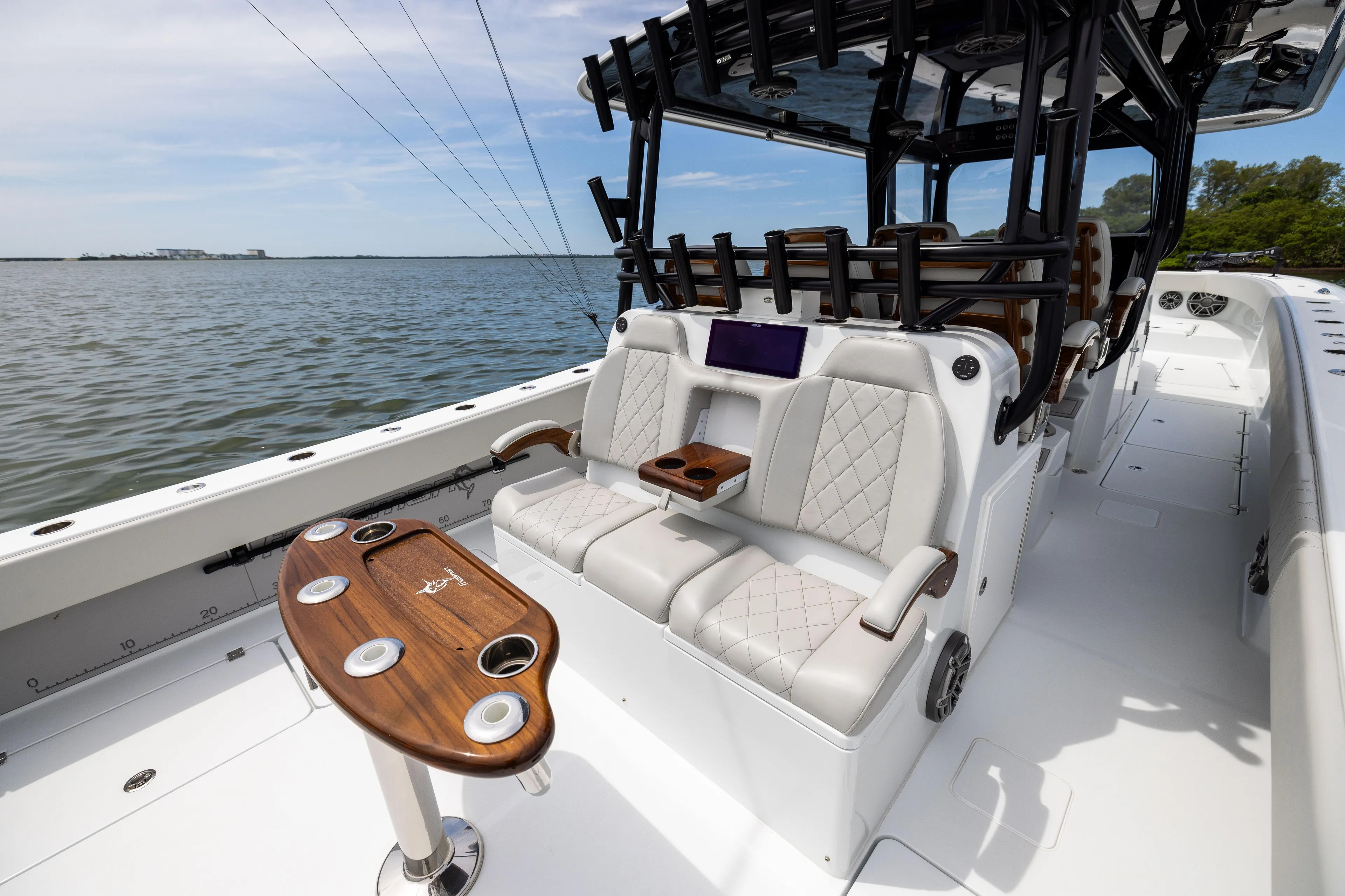  Yacht Photos Pics Luxurious 2025 Freeman 42 LR boat interior with plush seating and elegant wooden table.