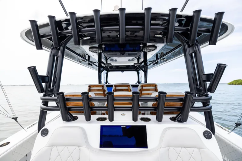  Yacht Photos Pics 2025 Freeman 42 LR boat interior with rod holders and seating, on calm water.