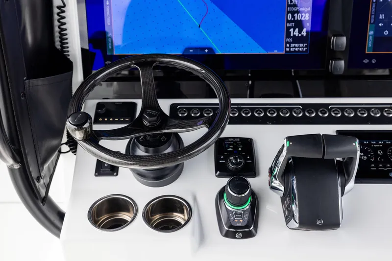  Yacht Photos Pics Control panel of 2025 Freeman 42 LR boat with steering wheel and navigation display.