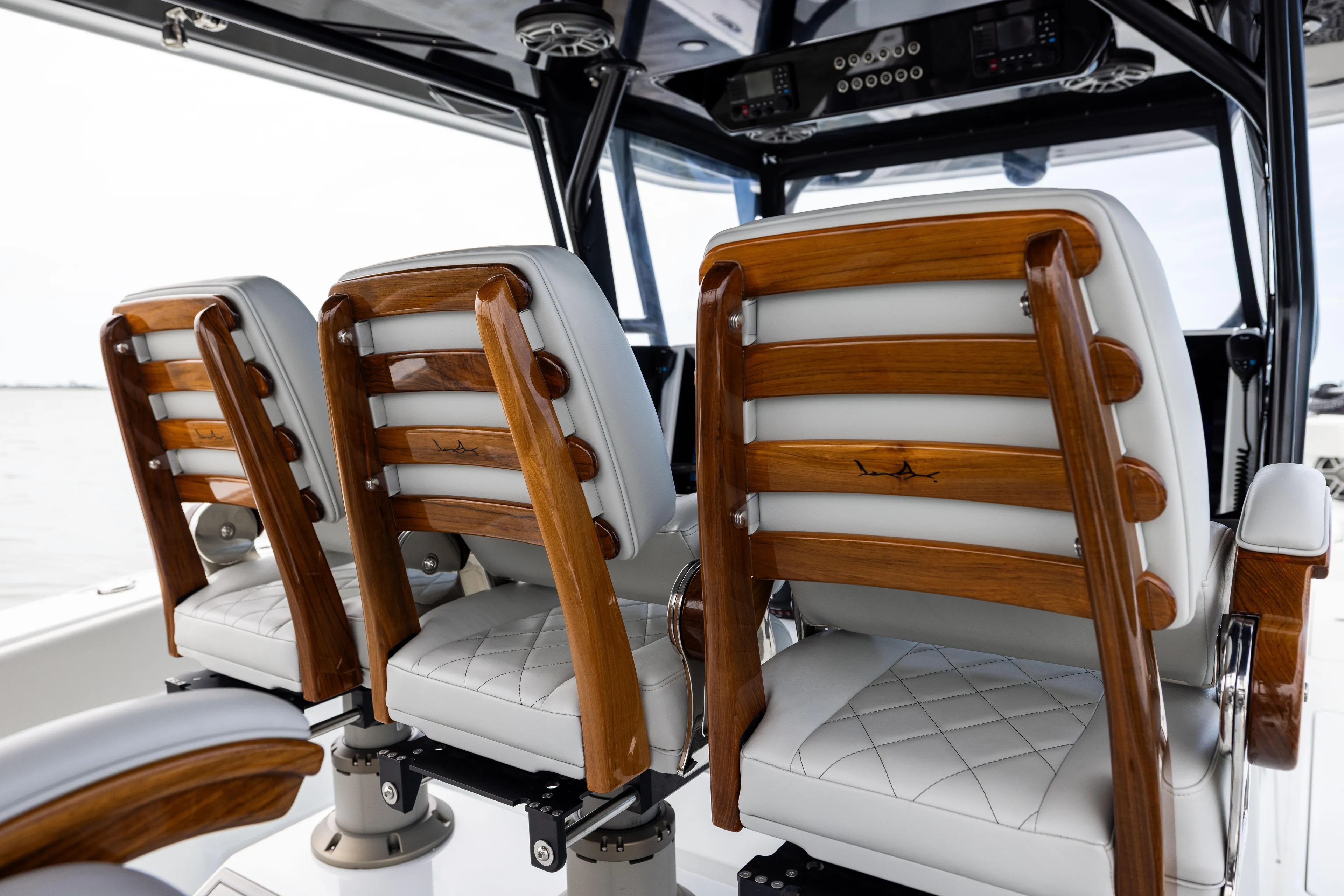  Yacht Photos Pics Luxury seating on 2025 Freeman 42 LR boat with elegant wood and leather design.