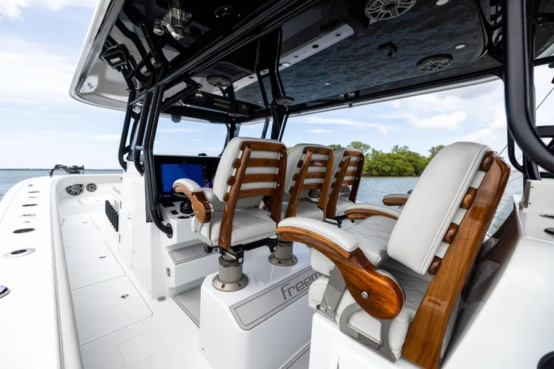  Yacht Photos Pics Interior of 2025 Freeman 42 LR boat with luxurious seating and modern controls.