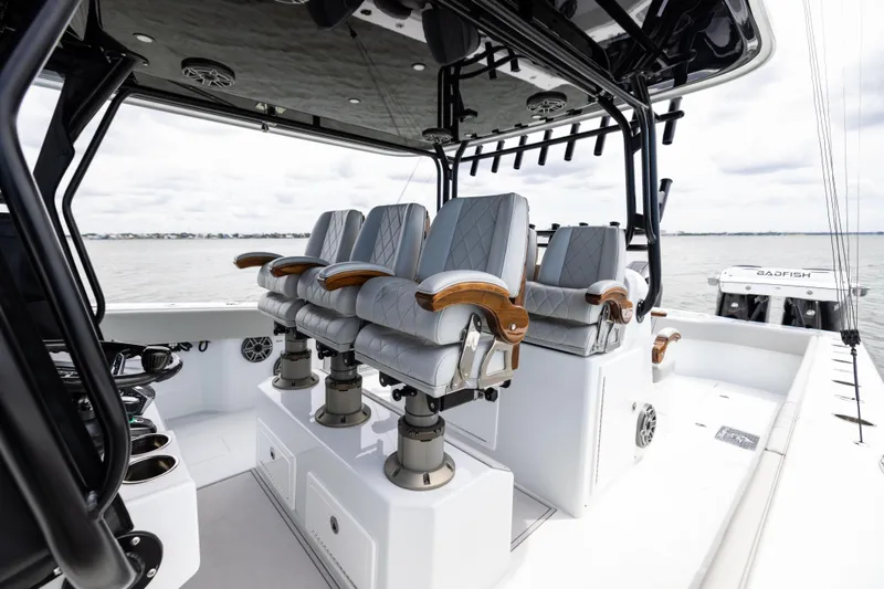  Yacht Photos Pics Luxury seating on 2025 Freeman 42 LR boat, featuring sleek design and ocean backdrop.