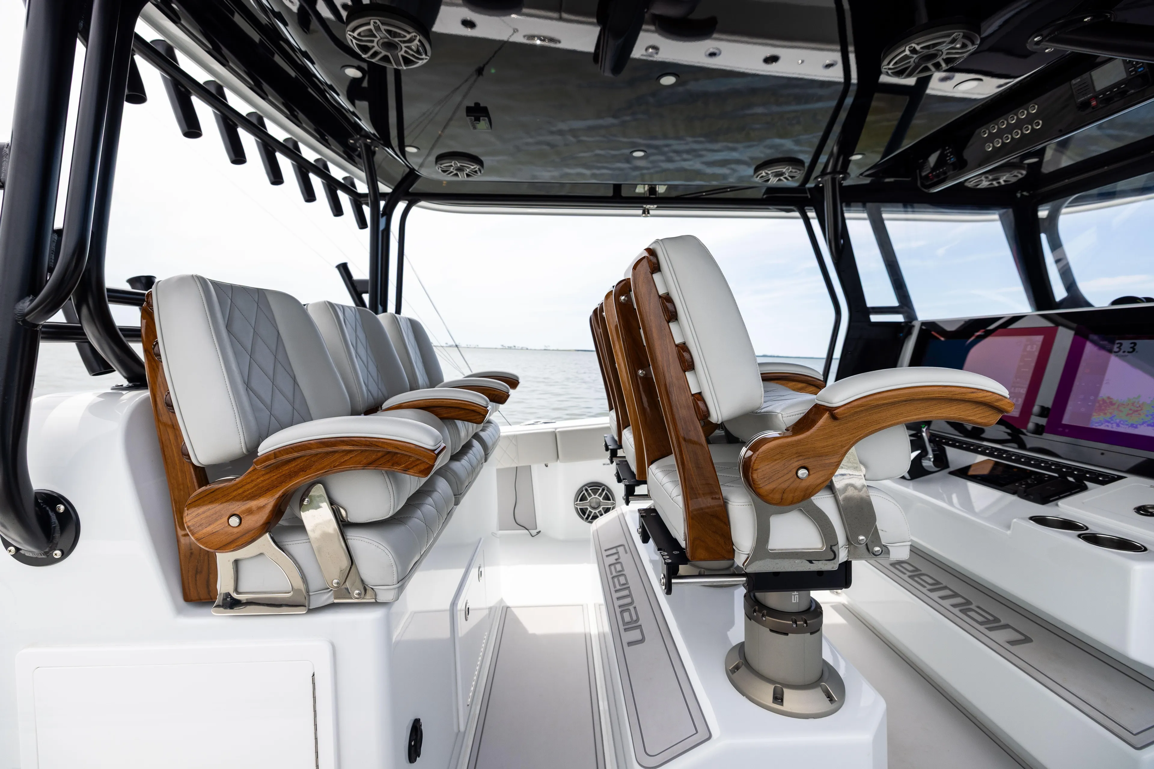  Yacht Photos Pics Luxury interior of 2025 Freeman 42 LR boat with elegant seating and advanced controls.