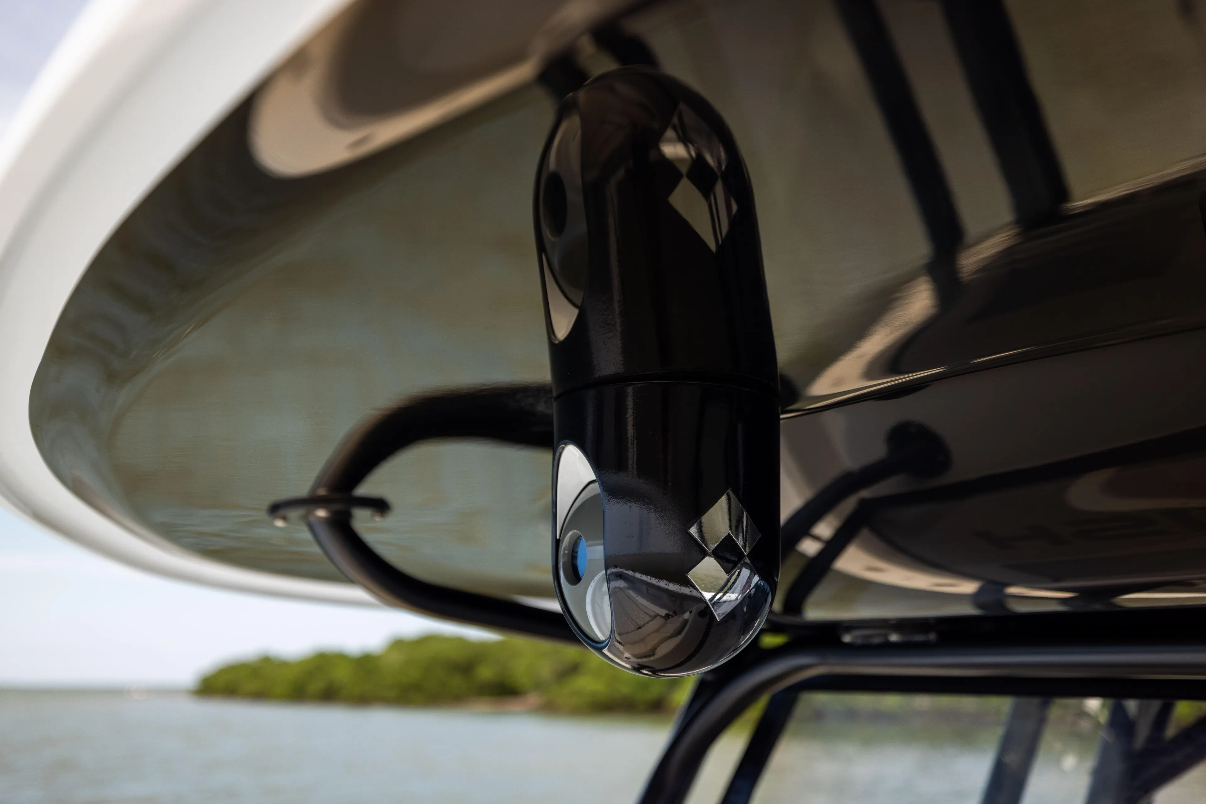  Yacht Photos Pics Close-up of a 2025 Freeman 42 LR boat camera under a canopy, with water and trees in the background.