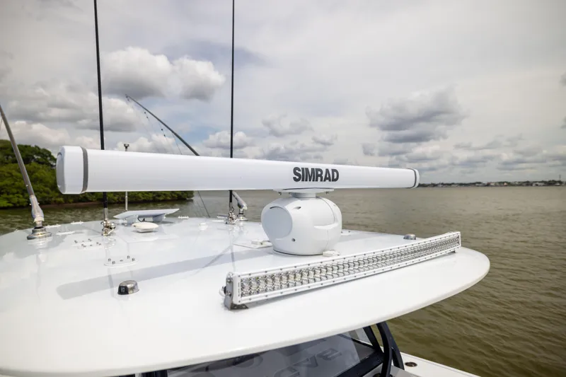  Yacht Photos Pics Radar system on 2025 Freeman 42 LR boat, with cloudy sky and water backdrop.