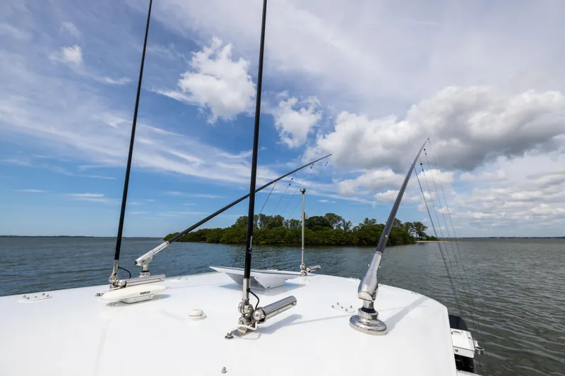  Yacht Photos Pics Fishing rods on a Freeman 42 LR boat, 2025 model, with scenic water and sky backdrop.