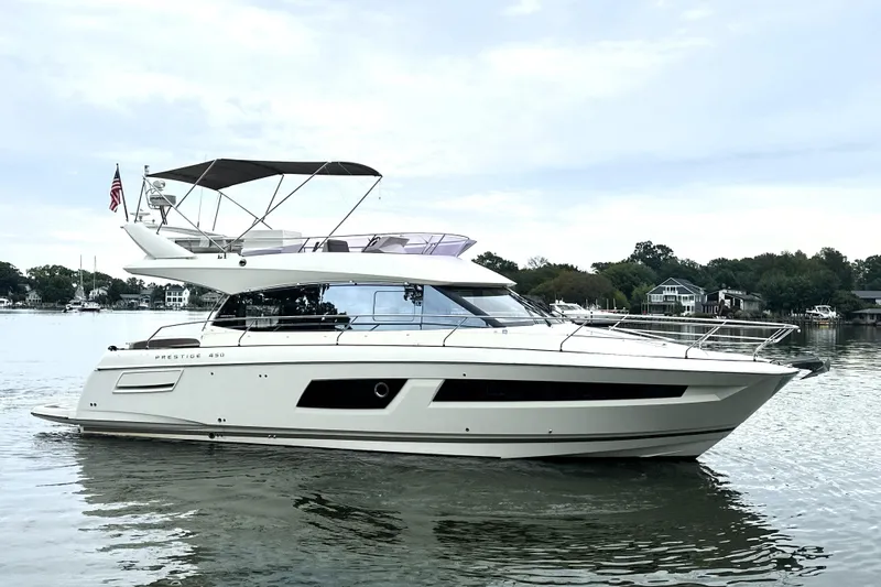 Snusie Q Yacht Photos Pics 2014 Prestige 450 yacht on calm water, showcasing sleek design and luxury features.