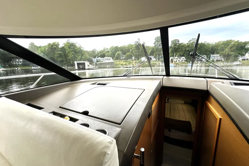 Snusie Q Yacht Photos Pics Interior view of 2014 Prestige 450 yacht, showcasing helm and cabin area.