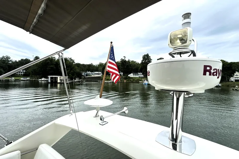 Snusie Q Yacht Photos Pics Prestige 450 yacht, 2014 model, with American flag on calm waters.
