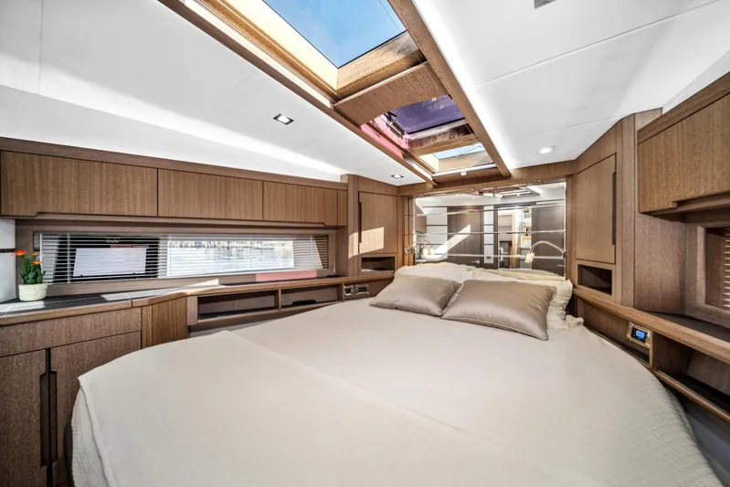  Yacht Photos Pics Luxurious interior of 2019 Galeon 560 Sky yacht with skylight and elegant wood finish.