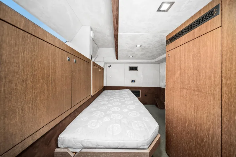  Yacht Photos Pics Interior cabin of 2019 Galeon 560 Sky yacht with wooden cabinetry and single bed.