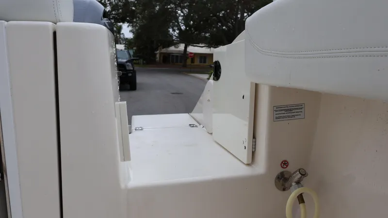 Yacht Photos Pics 2023 Cobia 280 Center Console boat interior detail, featuring storage compartment and seating.