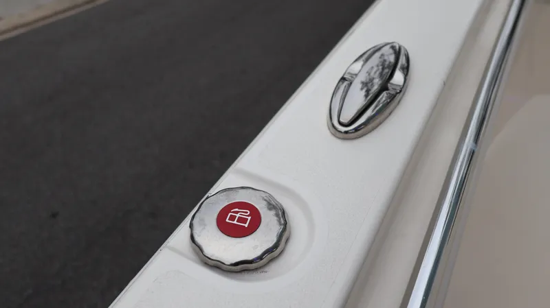  Yacht Photos Pics Close-up of 2023 Cobia 280 Center Console boat detail with red button and chrome handle.