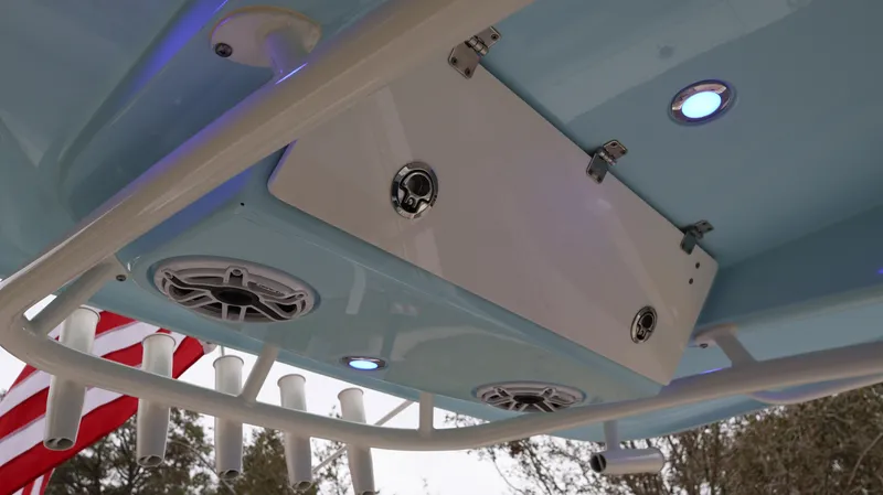  Yacht Photos Pics 2023 Cobia 280 Center Console boat with speakers and rod holders under the T-top.