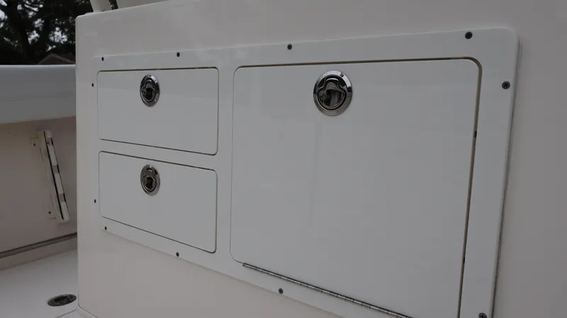  Yacht Photos Pics 2023 Cobia 280 Center Console storage compartments with sleek white finish.
