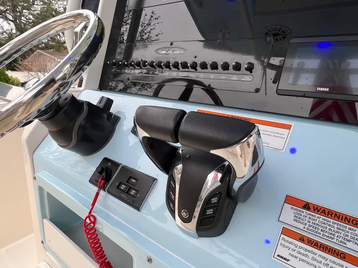 Yacht Photos Pics 2023 Cobia 280 Center Console helm with steering wheel and throttle controls.