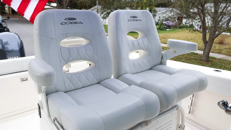  Yacht Photos Pics 2023 Cobia 280 Center Console boat seats with gray upholstery and armrests.