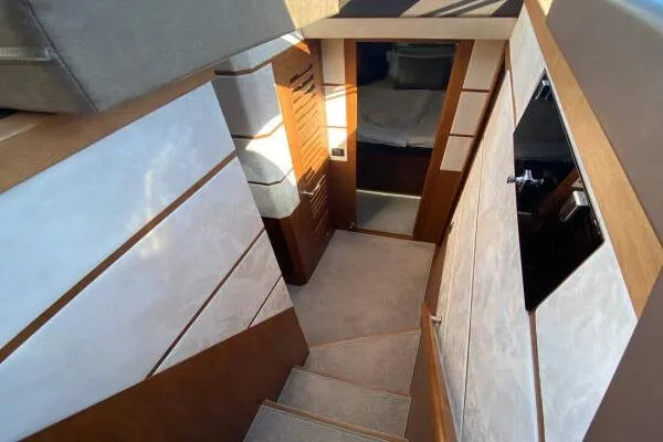  Yacht Photos Pics Interior view of 2014 Galeon 550 Fly yacht, featuring modern wood and white paneling.