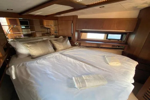  Yacht Photos Pics Luxurious bedroom interior of 2014 Galeon 550 Fly yacht with elegant wood finishes.