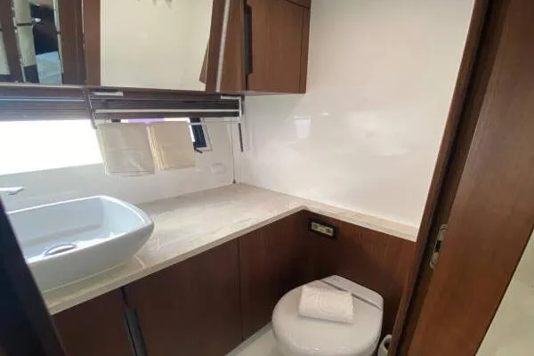  Yacht Photos Pics Luxurious bathroom in 2014 Galeon 550 Fly yacht with modern fixtures and wooden cabinetry.