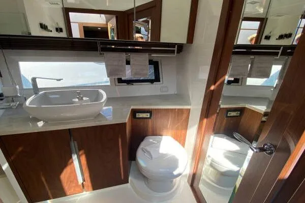  Yacht Photos Pics Luxurious bathroom in 2014 Galeon 550 Fly yacht with modern fixtures and wood accents.