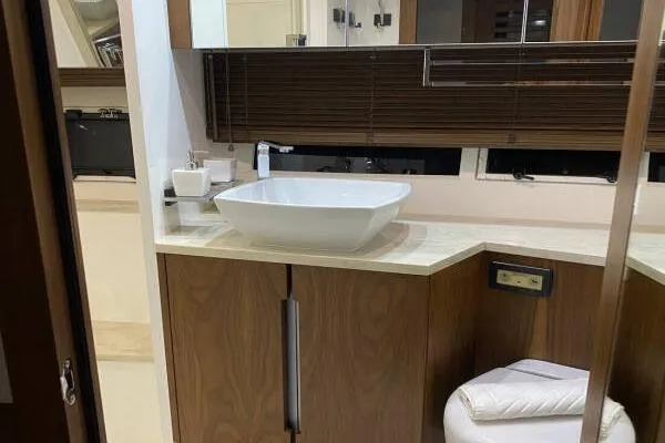  Yacht Photos Pics Luxurious bathroom interior of 2014 Galeon 550 Fly yacht with modern sink and wooden cabinetry.