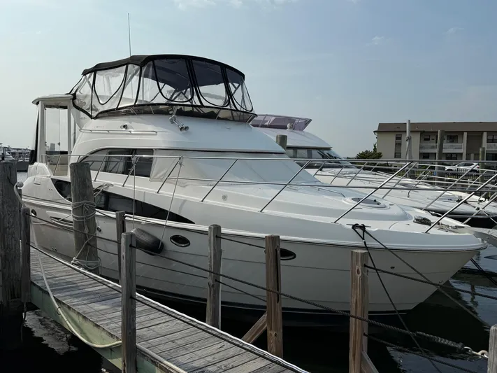 Jamm Yacht Photos Pics 2005 Meridian 459 Motoryacht docked at marina, featuring sleek design and spacious upper deck.