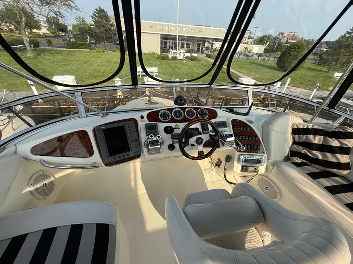 Jamm Yacht Photos Pics Interior view of 2005 Meridian 459 Motoryacht cockpit with luxurious seating and control panel.