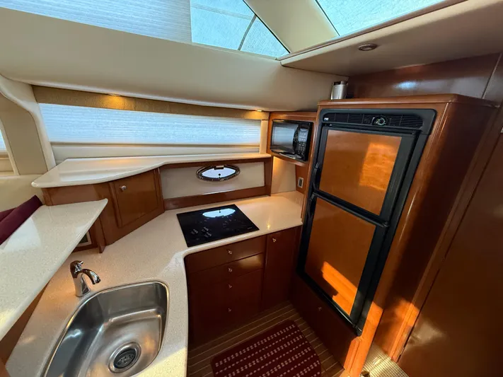 Jamm Yacht Photos Pics Luxurious kitchen interior of 2005 Meridian 459 Motoryacht with modern appliances and wood finish.