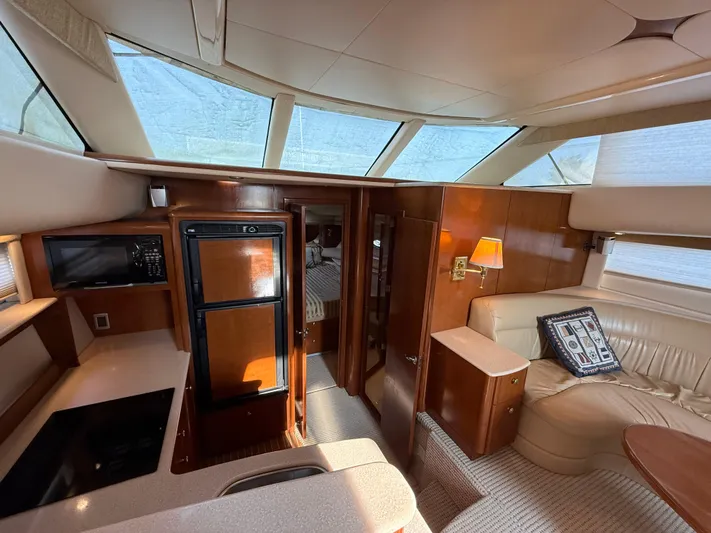 Jamm Yacht Photos Pics Interior of 2005 Meridian 459 Motoryacht with modern kitchen and cozy seating area.