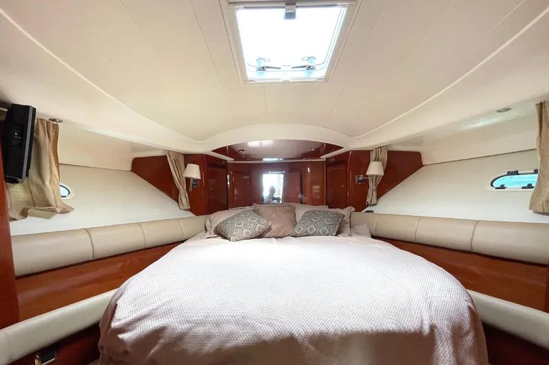 Our Three Buoys Yacht Photos Pics Luxurious cabin interior of 2007 Prestige 46 Flybridge yacht with cozy bedding.