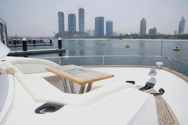  Yacht Photos Pics Luxurious 2018 Sunseeker 95 yacht with city skyline view in the background.