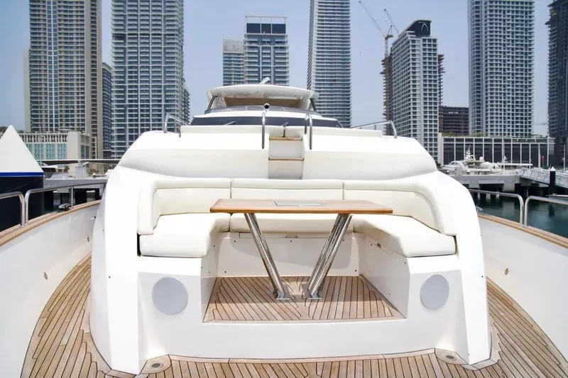  Yacht Photos Pics Luxurious 2018 Sunseeker 95 yacht with elegant deck seating, set against a city skyline.
