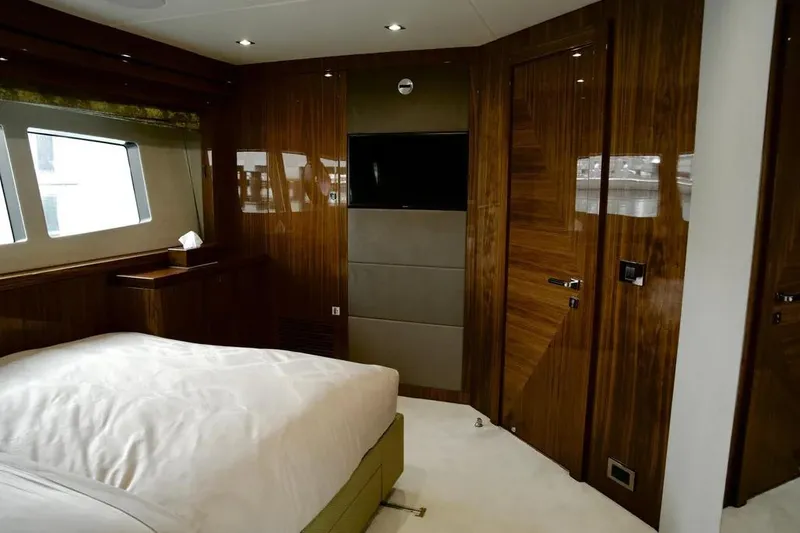  Yacht Photos Pics Luxurious Sunseeker 95 yacht bedroom interior, 2018 model, featuring elegant wood paneling and modern design.