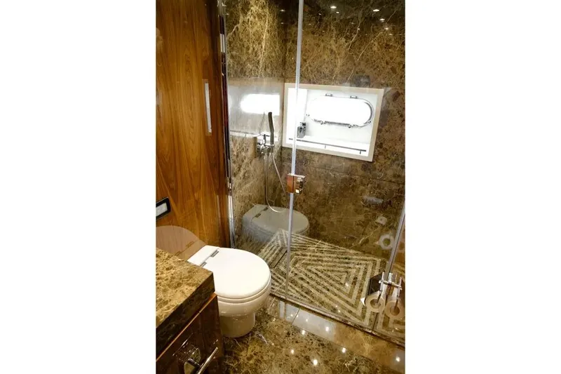  Yacht Photos Pics Luxurious marble bathroom in 2018 Sunseeker 95 yacht, featuring modern fixtures and elegant design.