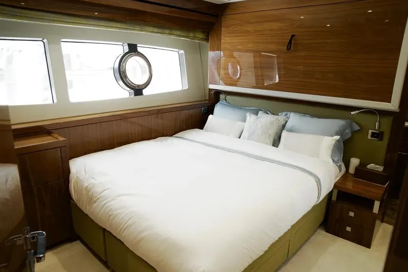  Yacht Photos Pics Luxurious bedroom interior on 2018 Sunseeker 95 yacht with elegant wood paneling.