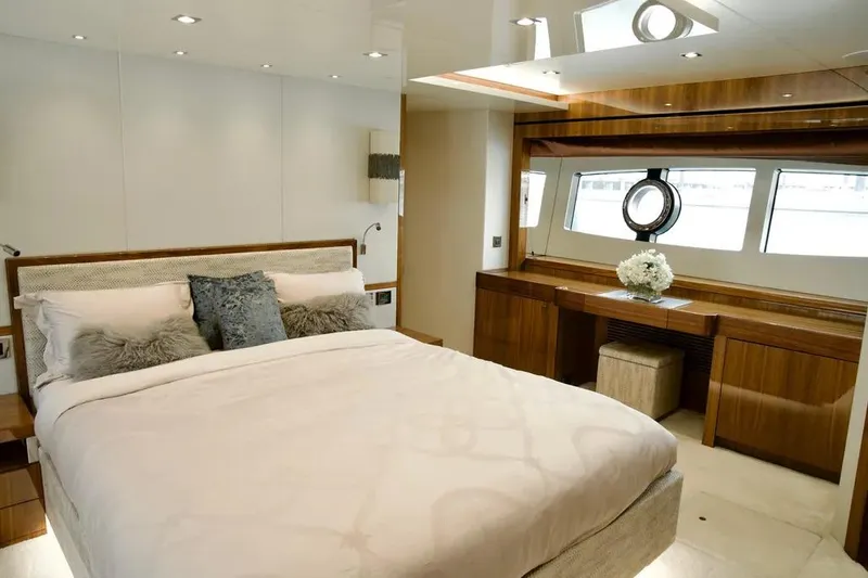  Yacht Photos Pics Luxurious bedroom interior of 2018 Sunseeker 95 yacht with elegant decor and natural light.