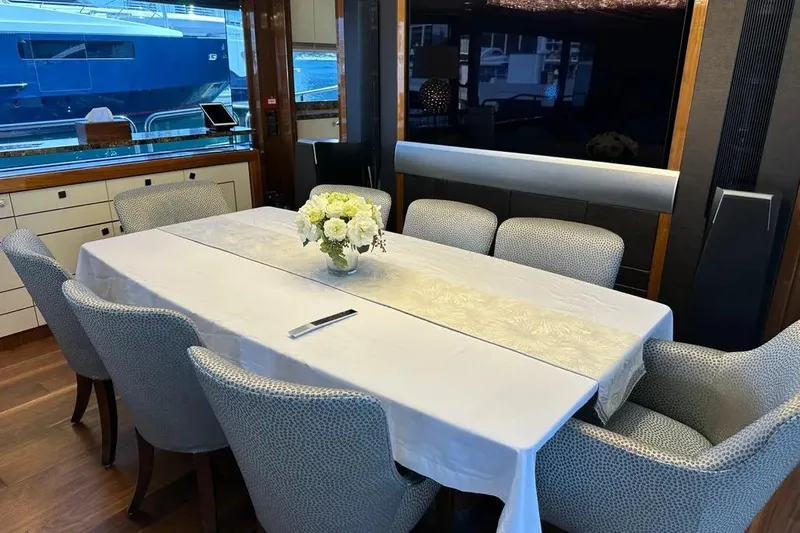  Yacht Photos Pics Luxurious dining area on a 2018 Sunseeker 95 yacht with elegant table setting.