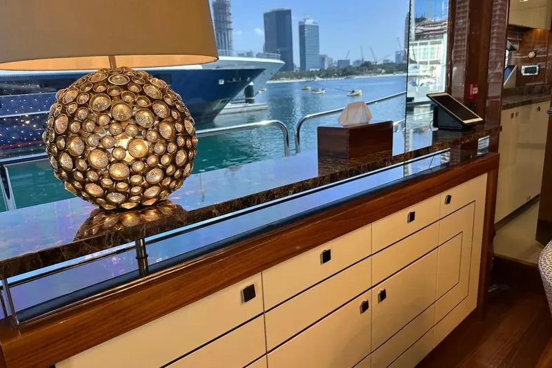  Yacht Photos Pics Luxurious interior of 2018 Sunseeker 95 yacht with decorative lamp and marina view.