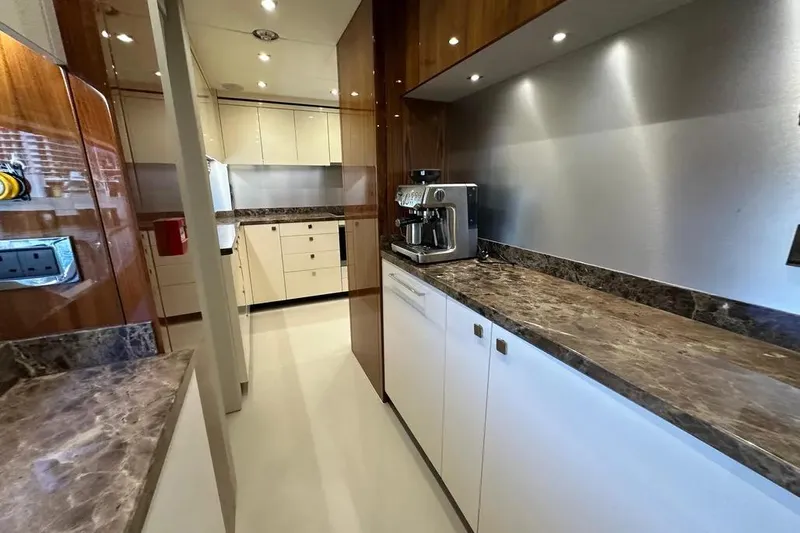  Yacht Photos Pics Luxurious kitchen interior of 2018 Sunseeker 95 yacht with marble countertops and modern appliances.