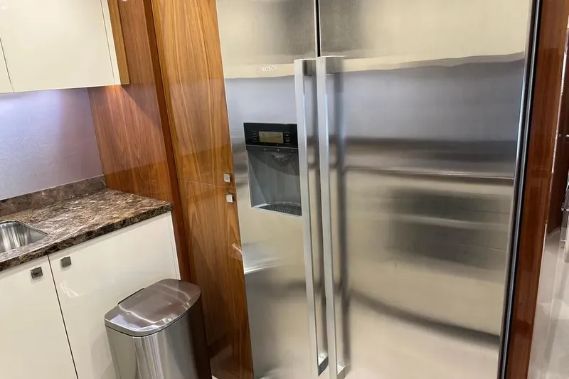  Yacht Photos Pics Luxurious kitchen interior on a 2018 Sunseeker 95 yacht with stainless steel appliances.