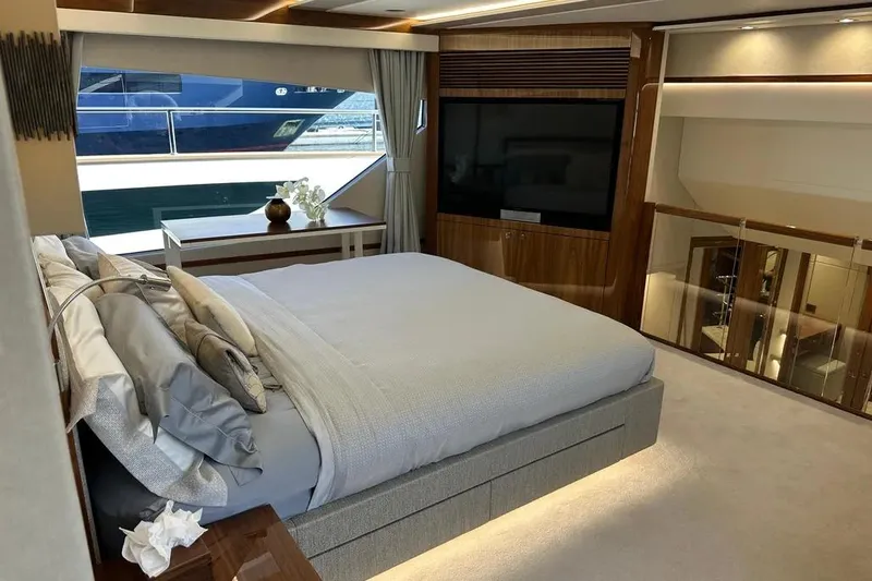  Yacht Photos Pics Luxurious bedroom interior on 2018 Sunseeker 95 yacht, featuring elegant design and large window.