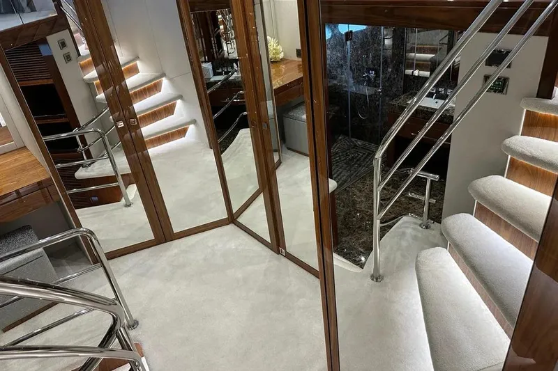  Yacht Photos Pics Luxurious interior of 2018 Sunseeker 95 yacht with elegant stairs and mirrored walls.
