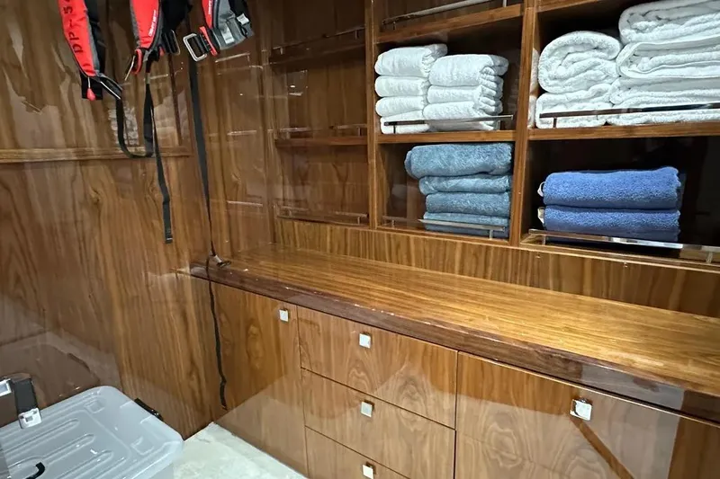  Yacht Photos Pics Luxurious wooden interior of 2018 Sunseeker 95 yacht with neatly stacked towels.
