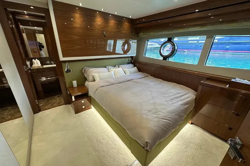  Yacht Photos Pics Luxurious bedroom interior of 2018 Sunseeker 95 yacht with elegant wood finishes.