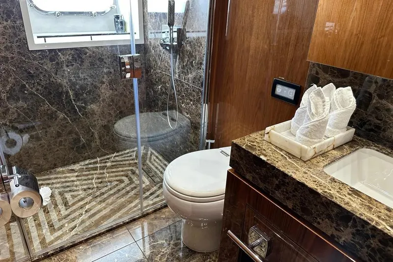  Yacht Photos Pics Luxurious bathroom in 2018 Sunseeker 95 yacht with marble finishes and modern amenities.