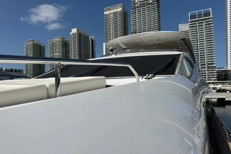  Yacht Photos Pics Luxurious 2018 Sunseeker 95 yacht docked with city skyline backdrop.