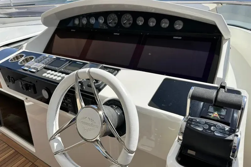  Yacht Photos Pics 2018 Sunseeker 95 yacht helm with modern controls and steering wheel.