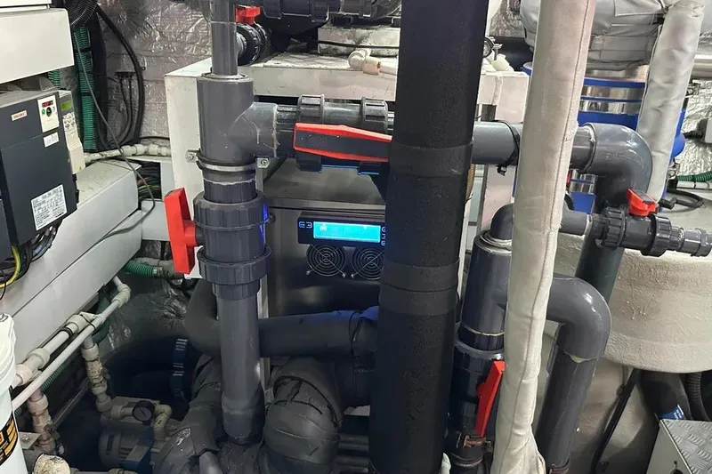  Yacht Photos Pics Engine room of a 2018 Sunseeker 95 yacht, featuring complex piping and machinery.